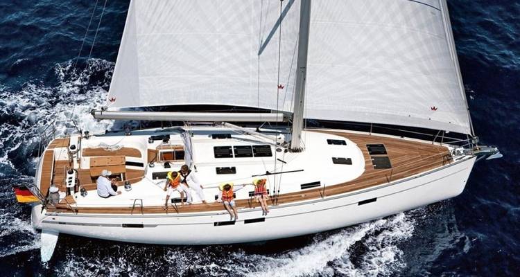 Family on a sailboat with full white sails.