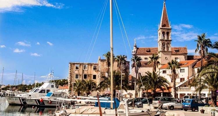 Scenic port with a clock tower and docked boats.