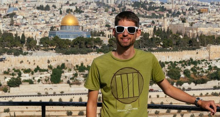 Person posing in front of Jerusalem's Dome of the Rock.