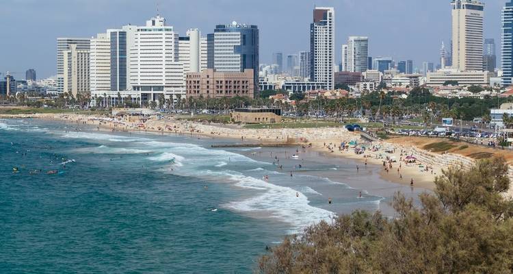 Tel Aviv beachfront with city skyline.