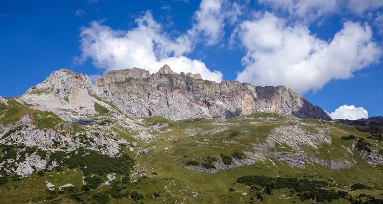 Mountain landscape with blue sky and clouds.