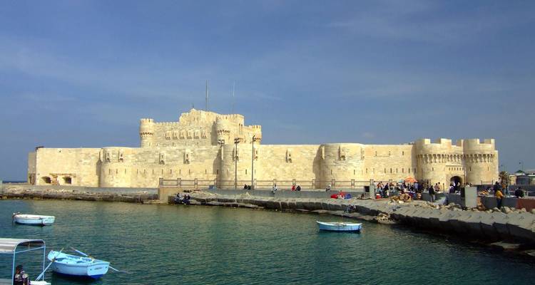 Historisch kustfort Fort Qaitbay in Alexandrië omringd door blauwe Middellandse Zee-wateren.
