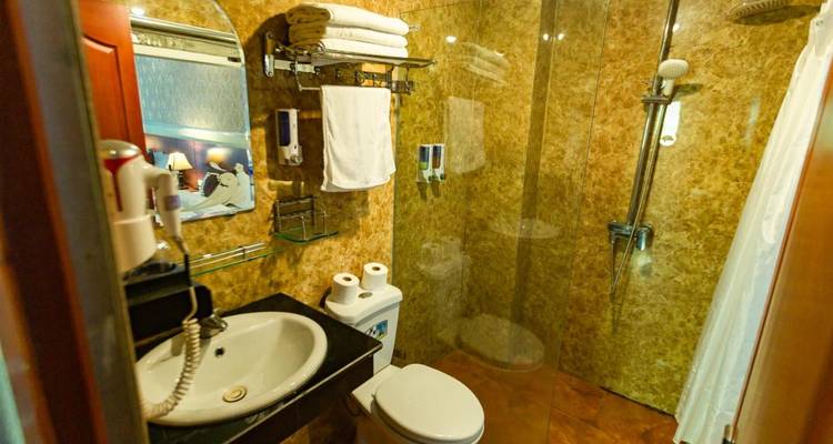 An interior bathroom with shower facilities.