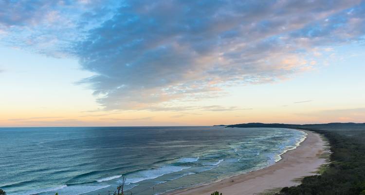 Expansive view of a sandy beach meeting the ocean.