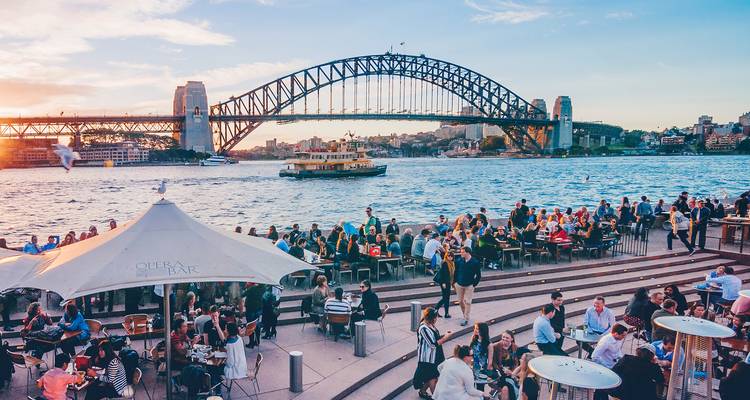 Sydney Harbour Bridge and waterfront dining scene.