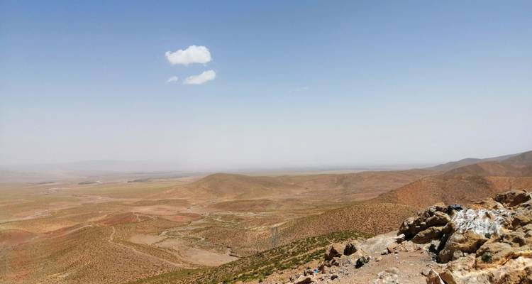 Expansive desert view with mountains in the distance.