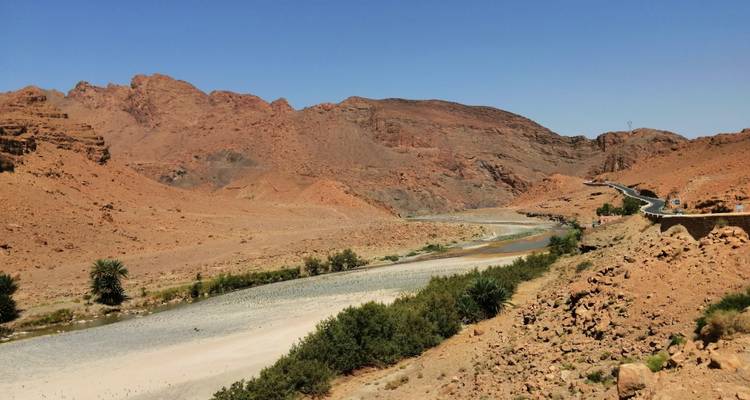 Arid landscape with rocky hills and sparse vegetation.