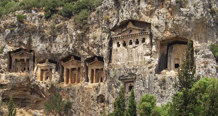 Ancient Lycian rock-cut tombs carved high in a rugged cliff face at Dalyan.