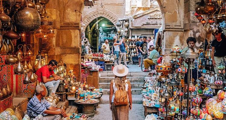Busy market street with vibrant stalls, likely Khan Al-Khalili, Cairo.