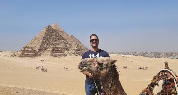 Man with camel near the pyramids.