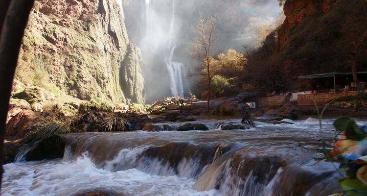 Base of waterfall with natural pools and mist.