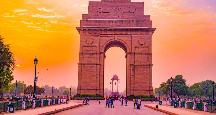 India Gate at sunset with people around
