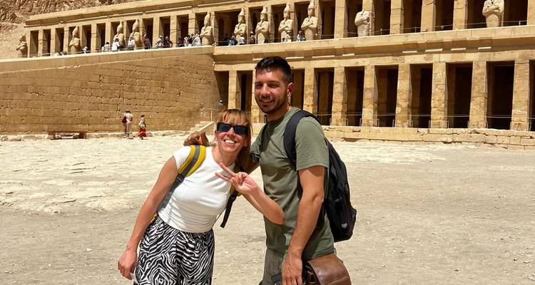 Deux amis posent de manière enjouée devant la cour du temple d'Hatchepsout.