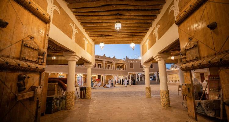 Marché traditionnel avec architecture ornée et éclairage du soir.