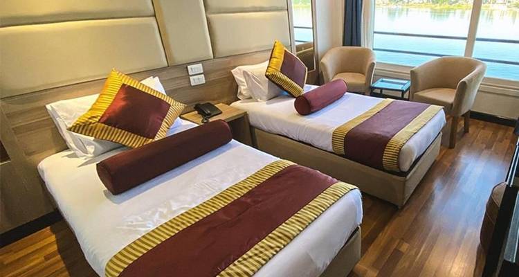 Modern room interior with two single beds and a window view.