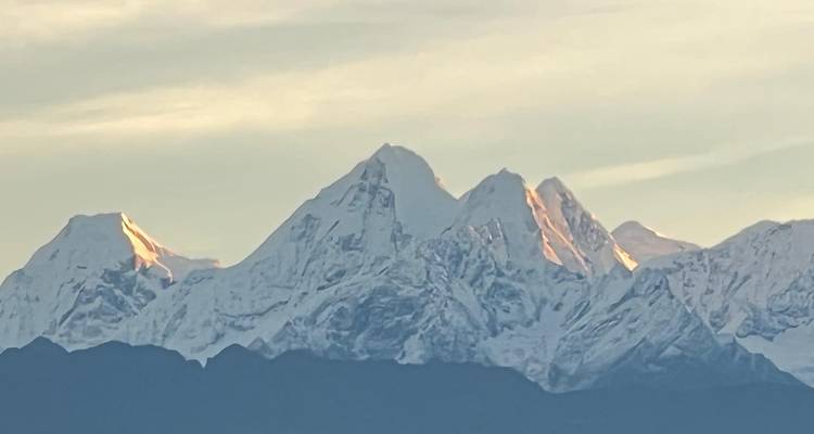 Snowy mountain peaks at sunrise.