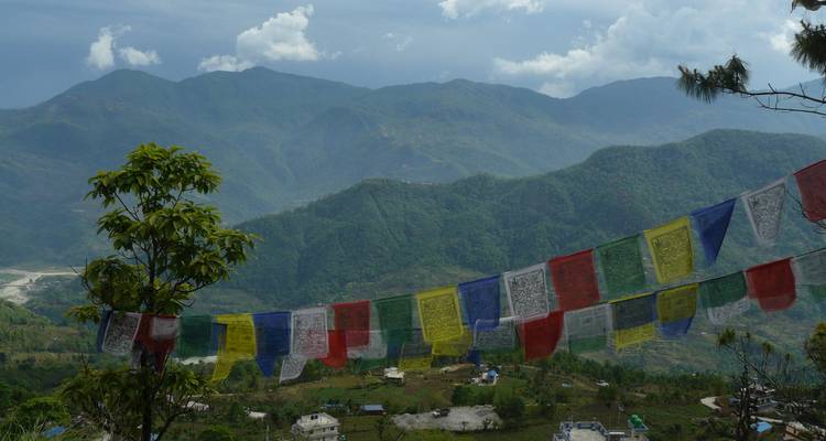 View of prayer flags against a mountain backdrop.