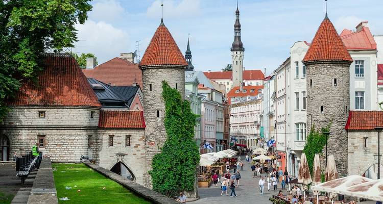 Vibrant street scene with classic towers and people exploring.