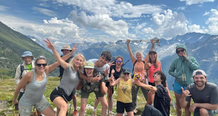 Group posing happily with mountains in the background.