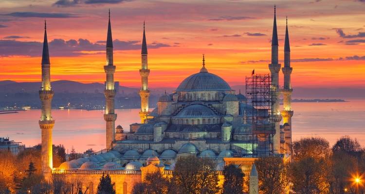 Majestic mosque overlooking a sunset-stained skyline.