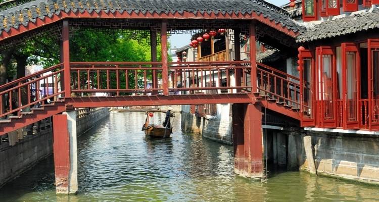 Traditional Chinese water town with a wooden bridge.