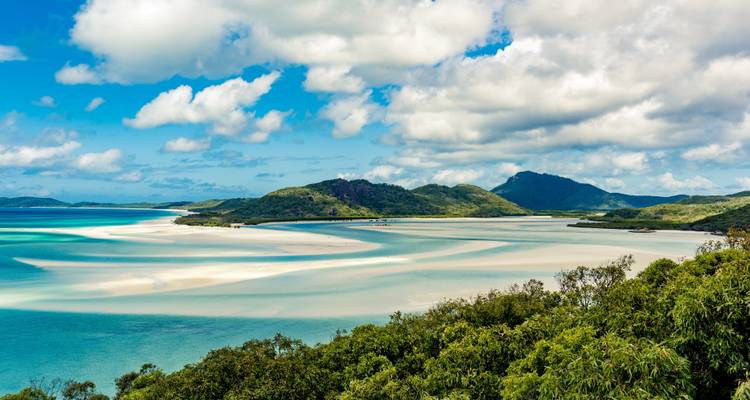 Aerial shot of Whitsunday Islands with clear water and islands.