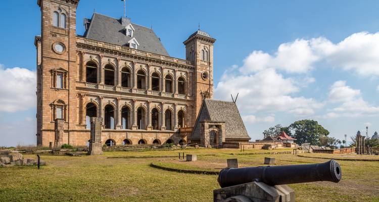 Ancient palace with cannons on the lawn.