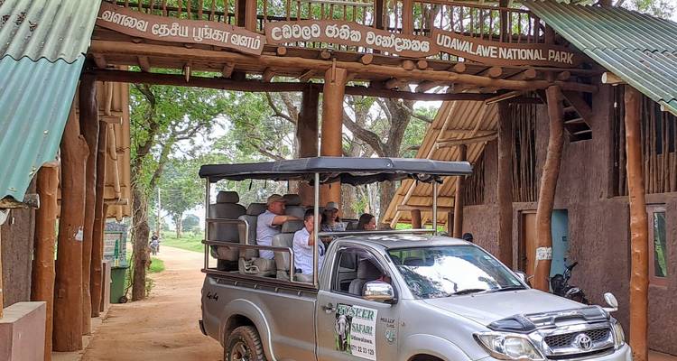 Entrance to Udawalawe National Park with a safari vehicle.