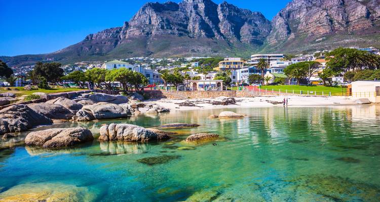 Scenic view of seaside homes and mountains.