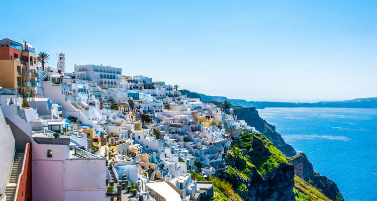 Whitewashed cliff-top village of Santorini overlooking the deep blue Aegean Sea