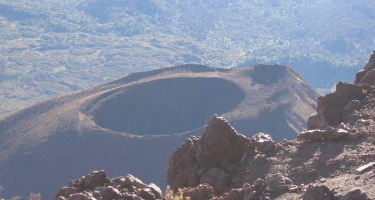 A volcanic crater in a rocky mountainous area.