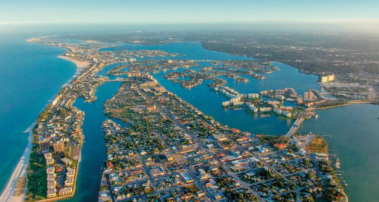 Aerial view of a coastal city with a complex waterway system.