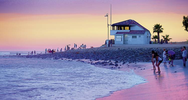 People enjoying a sunset at a beach