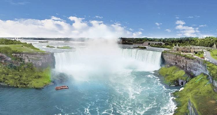 Niagara Falls with a boat in the mist, viewed from above.