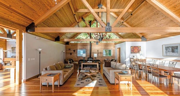 Spacious lodge interior with wooden architecture.