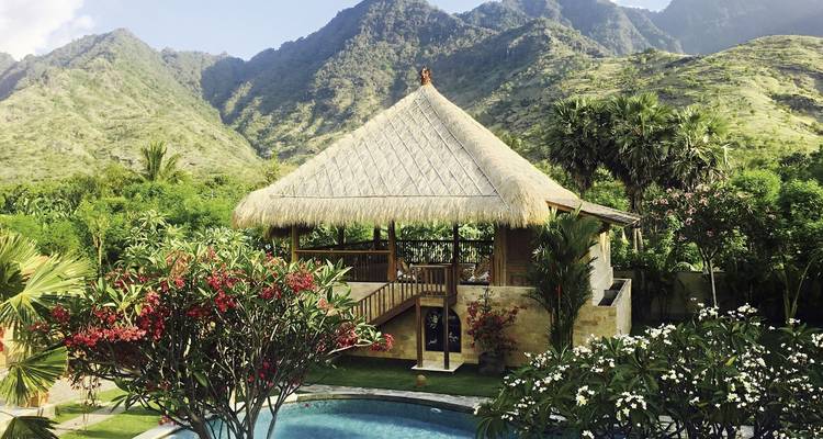 Pabellón tradicional indonesio con un telón de fondo montañoso.