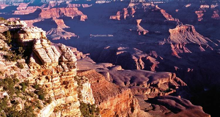 Grand Canyon view with layered cliffs and shadows.