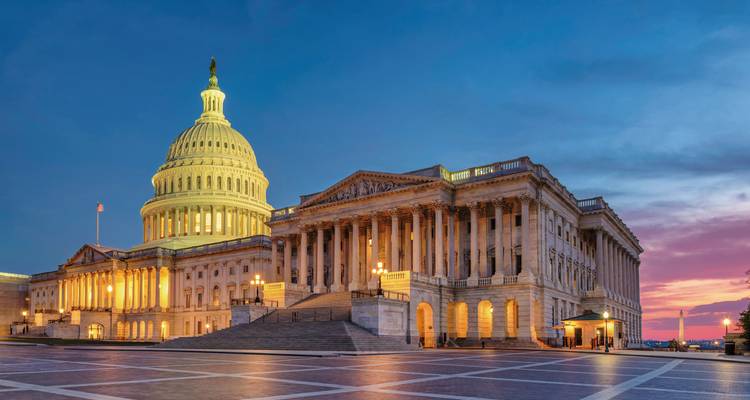 US Capitol building in Washington DC lit up at dusk.