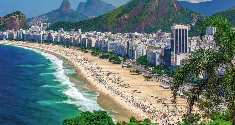 Copacabana Beach with city skyline and mountains.