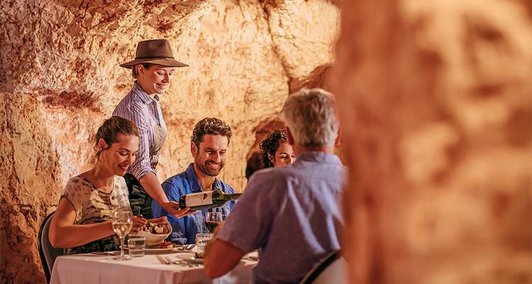 People dining inside a cave.