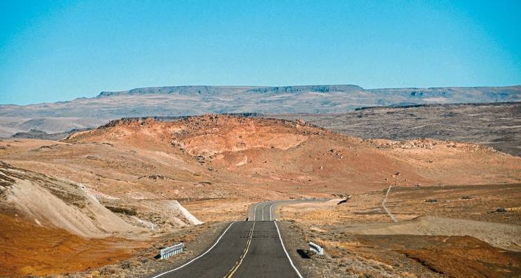 Winding road through a barren, arid landscape.