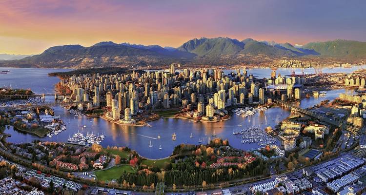 Aerial view of Vancouver cityscape with a colorful sunset.