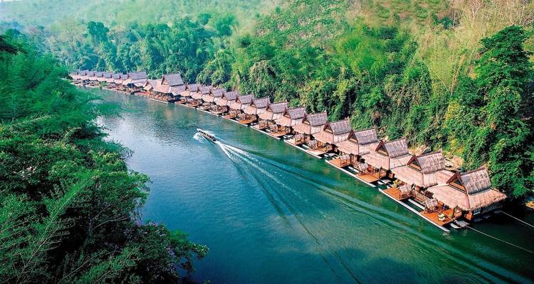 Aerial view of floating bungalows along a river.