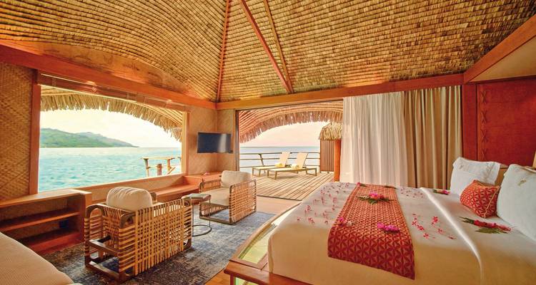 Luxury bungalow interior with ocean view.