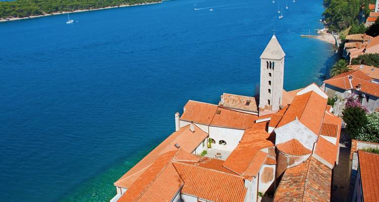 Aerial view of a coastal town with a bell tower.
