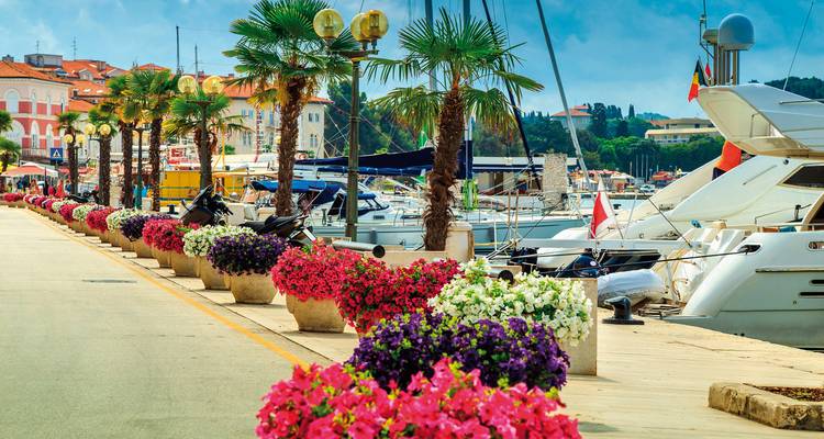 Boat dock with colorful flowers and yachts in Opatija.