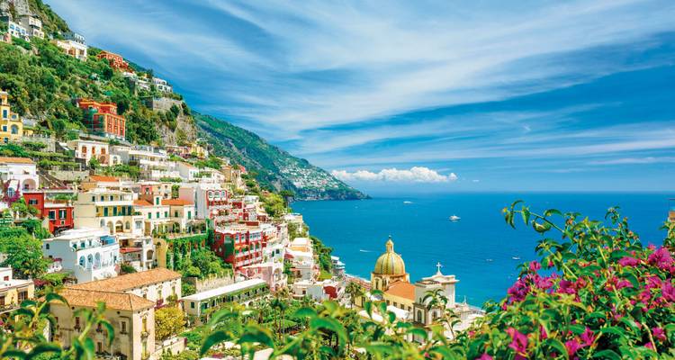Colorful hillside town overlooking blue sea