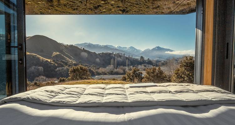 Vue intérieure d'une cabane confortable avec vue panoramique sur la montagne.