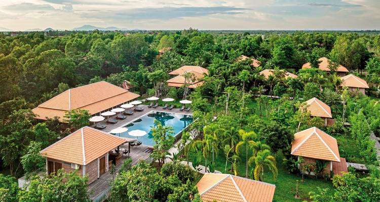 Aerial view of a resort with tropical greenery and pool