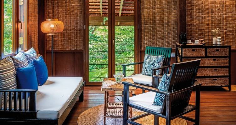 Cozy lounge area with bamboo walls and cushions